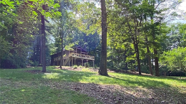 1221 Garden Ln, Middlesex, NY 14507 - view of grassy yard with a deck, stairs, and a wooded view