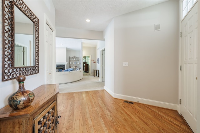 10 Bristol View Dr, Perinton, NY 14450 - hallway with light wood-style floors, recessed lighting, and a textured ceiling