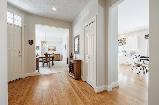 10 Bristol View Dr, Perinton, NY 14450 - foyer with light wood-type flooring, plenty of natural light, and a textured ceiling