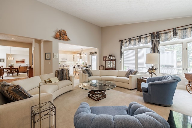 10 Bristol View Dr, Perinton, NY 14450 - living room featuring carpet floors, a chandelier, and lofted ceiling