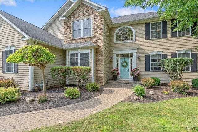 1002 Oreste St, Camillus, NY 13031 - view of front of house featuring roof with shingles and stone siding
