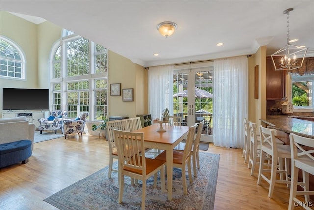 1002 Oreste St, Camillus, NY 13031 - dining space featuring a chandelier, french doors, light wood-type flooring, crown molding, and recessed lighting
