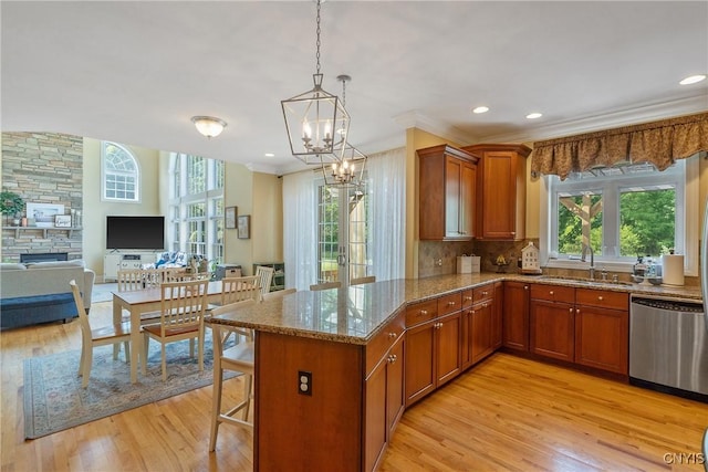 1002 Oreste St, Camillus, NY 13031 - kitchen with stainless steel dishwasher, light wood-type flooring, plenty of natural light, stone countertops, and recessed lighting