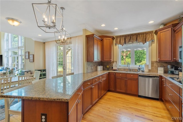 1002 Oreste St, Camillus, NY 13031 - kitchen with stainless steel appliances, a chandelier, brown cabinets, light wood-style flooring, and ornamental molding
