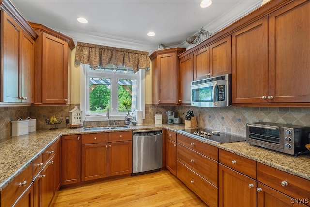1002 Oreste St, Camillus, NY 13031 - kitchen with appliances with stainless steel finishes, brown cabinets, light wood finished floors, tasteful backsplash, and light stone countertops