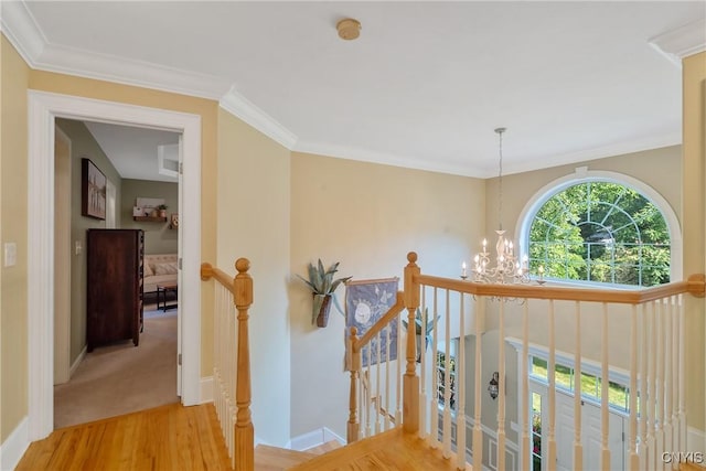 1002 Oreste St, Camillus, NY 13031 - corridor with an upstairs landing, a chandelier, wood finished floors, and ornamental molding