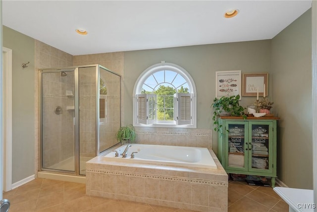 1002 Oreste St, Camillus, NY 13031 - bathroom with tile patterned floors, a bath, a stall shower, and recessed lighting