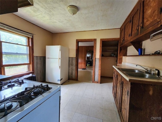 312 Richmond Ave Unit 314, Syracuse, NY 13204 - kitchen featuring white appliances, a wainscoted wall, a textured ceiling, and light countertops