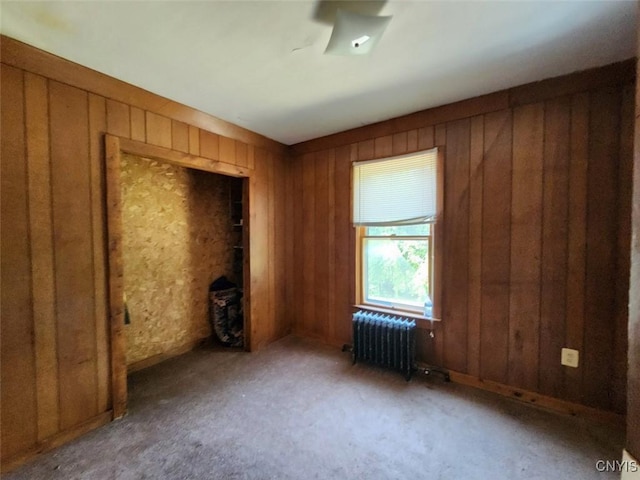 312 Richmond Ave Unit 314, Syracuse, NY 13204 - unfurnished bedroom featuring radiator heating unit, wood walls, and carpet flooring