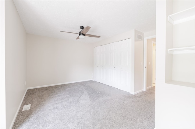 134 Jordache Ln, Ogden, NY 14559 - unfurnished bedroom with carpet, a closet, and a ceiling fan
