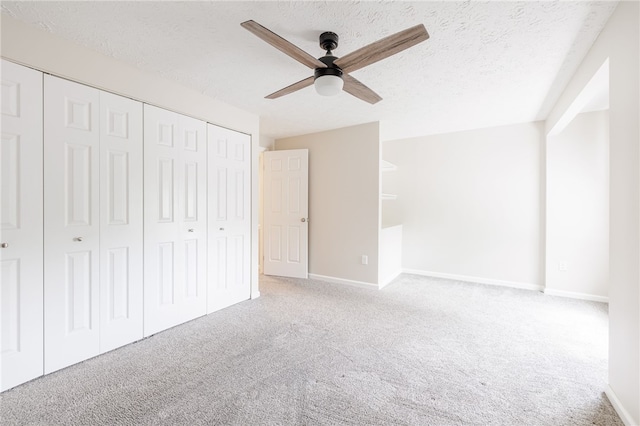 134 Jordache Ln, Ogden, NY 14559 - unfurnished bedroom with carpet floors, a closet, a textured ceiling, and ceiling fan
