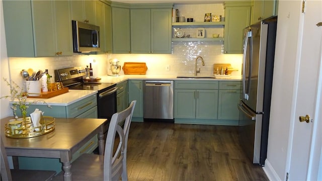164 S Fitzhugh St, Rochester, NY 14608 - kitchen with appliances with stainless steel finishes, green cabinetry, light countertops, decorative backsplash, and dark wood-type flooring