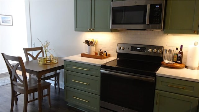 164 S Fitzhugh St, Rochester, NY 14608 - kitchen featuring green cabinetry, stainless steel microwave, and black range with electric cooktop