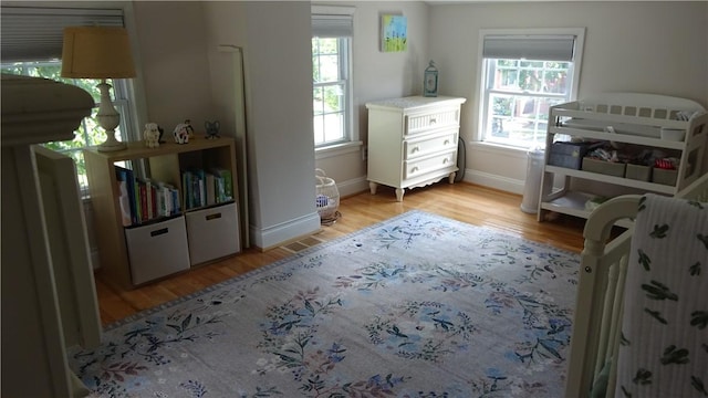 164 S Fitzhugh St, Rochester, NY 14608 - bedroom featuring light wood-type flooring and baseboards