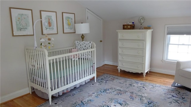 164 S Fitzhugh St, Rochester, NY 14608 - bedroom with wood finished floors, lofted ceiling, and a crib