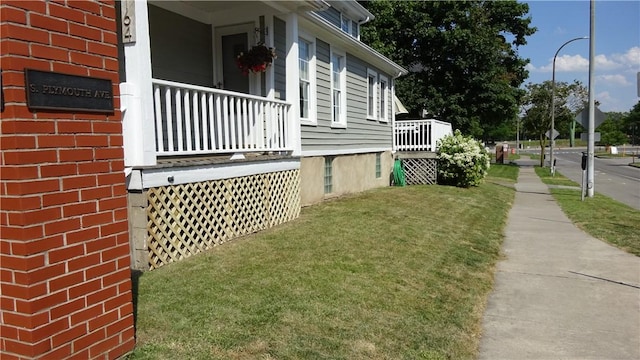 164 S Fitzhugh St, Rochester, NY 14608 - view of side of property with a lawn, brick siding, and covered porch