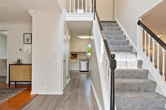 45 Hazel Bark, Gates, NY 14606 - stairway featuring wood finished floors and crown molding
