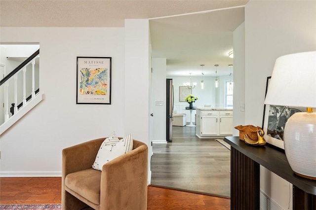 45 Hazel Bark, Gates, NY 14606 - sitting room featuring wood finished floors, stairway, and a chandelier