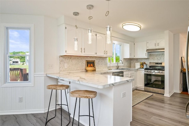 45 Hazel Bark, Gates, NY 14606 - kitchen featuring stainless steel appliances, a peninsula, light countertops, white cabinets, and a kitchen bar