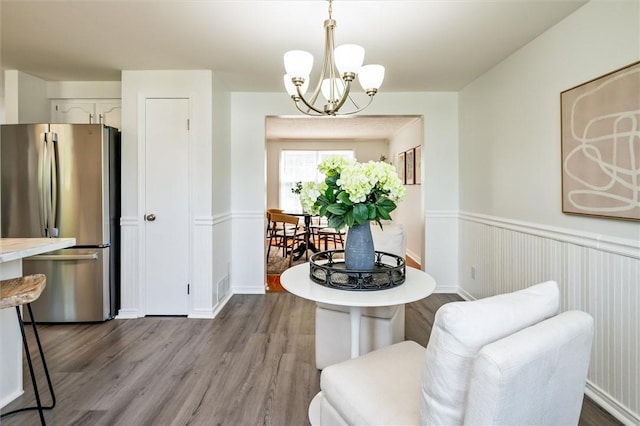 45 Hazel Bark, Gates, NY 14606 - dining room with wood finished floors, a chandelier, and wainscoting