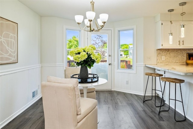 45 Hazel Bark, Gates, NY 14606 - dining space with dark wood-style flooring, a chandelier, and wainscoting