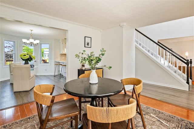 45 Hazel Bark, Gates, NY 14606 - dining room with stairs, a chandelier, wood finished floors, and crown molding