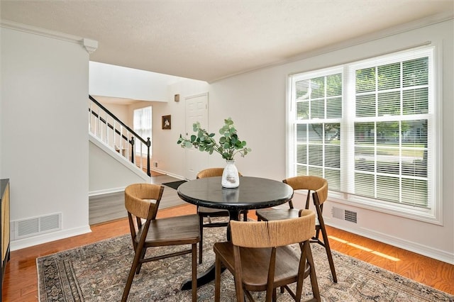 45 Hazel Bark, Gates, NY 14606 - dining area featuring stairway, wood finished floors, and ornamental molding