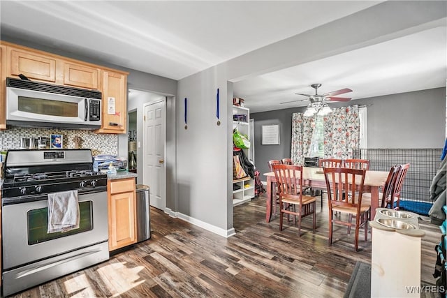 4034 Burke Pkwy, Hamburg, NY 14219 - kitchen with stainless steel gas stove, light brown cabinetry, dark wood-type flooring, and ceiling fan