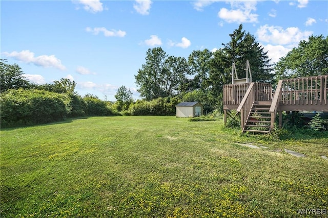 4034 Burke Pkwy, Hamburg, NY 14219 - view of green lawn with a storage unit, a deck, and stairs