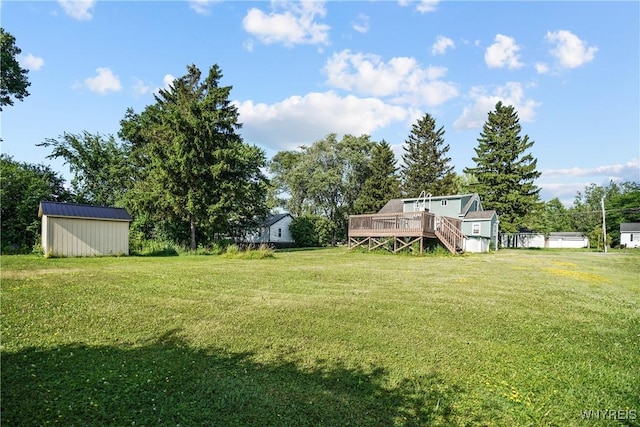 4034 Burke Pkwy, Hamburg, NY 14219 - view of grassy yard featuring a deck, a storage unit, and stairway