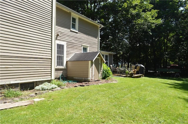 132 Main St, Unadilla, NY 13849 - view of green lawn featuring a storage unit
