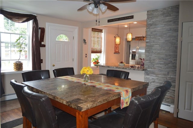132 Main St, Unadilla, NY 13849 - dining area featuring ceiling fan, wood finished floors, and a baseboard radiator