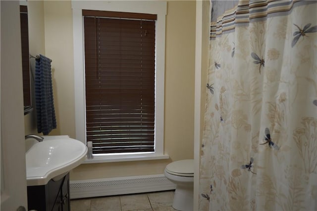 132 Main St, Unadilla, NY 13849 - full bathroom with a baseboard heating unit, tile patterned flooring, and vanity