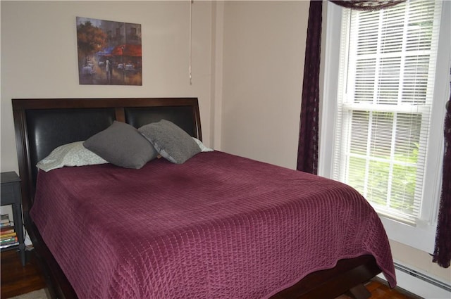 132 Main St, Unadilla, NY 13849 - bedroom featuring baseboard heating and wood finished floors