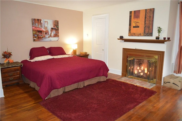 132 Main St, Unadilla, NY 13849 - bedroom with wood finished floors and a fireplace with flush hearth