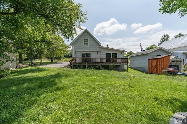 15243 Factory St, Clayton, NY 13632 - rear view of house featuring a storage unit, a wooden deck, and a lawn