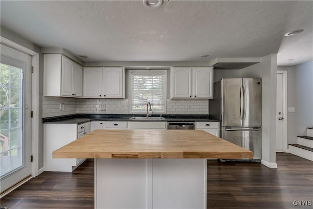 15243 Factory St, Clayton, NY 13632 - kitchen featuring appliances with stainless steel finishes, dark wood-style floors, plenty of natural light, and a textured ceiling