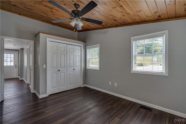15243 Factory St, Clayton, NY 13632 - unfurnished bedroom with multiple windows, wood ceiling, dark wood-style flooring, and a closet