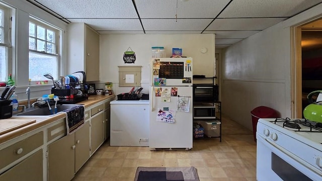 559 Maple Ave, Elmira City, NY 14904 - kitchen featuring a drop ceiling, white appliances, washer / dryer, and light countertops