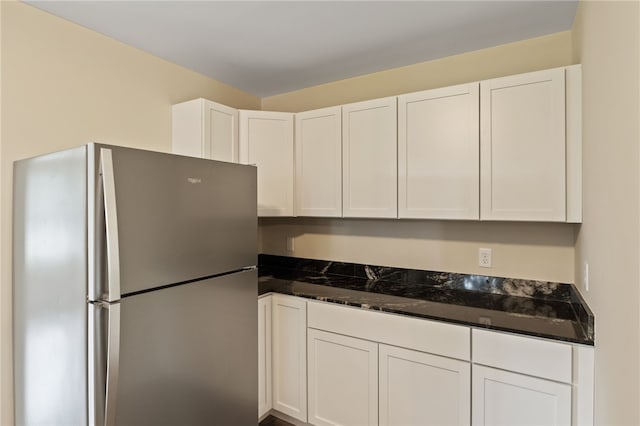 1728 Dalton Rd, Lima, NY 14485 - kitchen with freestanding refrigerator, white cabinets, and dark stone countertops