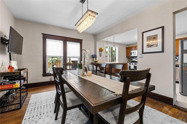 144 Whitfield Ave, Buffalo, NY 14220 - dining space featuring dark wood-style flooring and a chandelier
