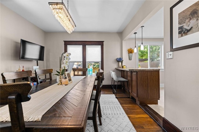 144 Whitfield Ave, Buffalo, NY 14220 - dining room with a chandelier and dark wood finished floors