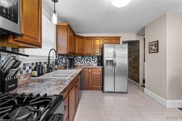 144 Whitfield Ave, Buffalo, NY 14220 - kitchen with stainless steel appliances, backsplash, and brown cabinetry
