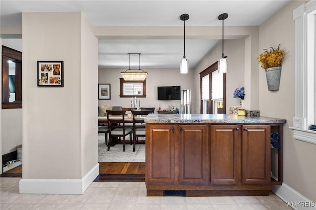 144 Whitfield Ave, Buffalo, NY 14220 - kitchen with pendant lighting, a peninsula, and stone counters