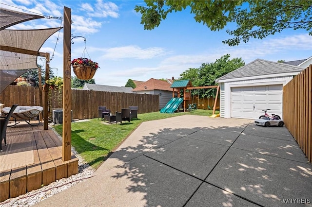 144 Whitfield Ave, Buffalo, NY 14220 - fenced backyard with a playground, concrete driveway, a detached garage, and a deck