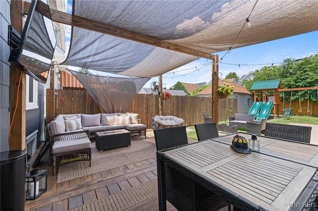 144 Whitfield Ave, Buffalo, NY 14220 - fenced backyard with an outdoor living space, a patio, a playground, and outdoor dining space