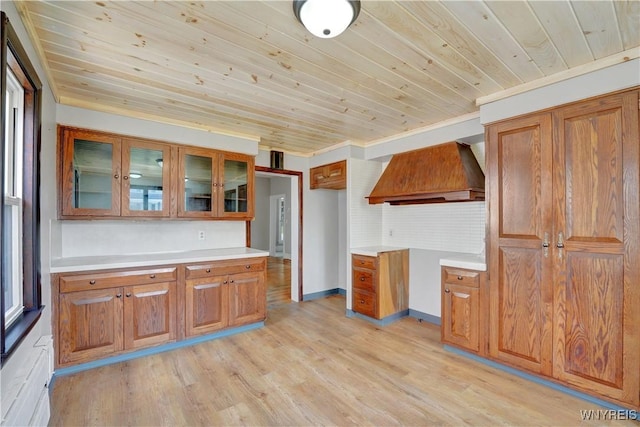 10470 Main St, North Collins, NY 14111 - kitchen featuring custom range hood, brown cabinetry, wooden ceiling, light wood-type flooring, and light countertops