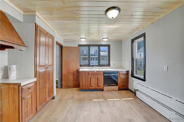 10470 Main St, North Collins, NY 14111 - kitchen with black dishwasher, baseboard heating, brown cabinetry, light countertops, and light wood-style floors