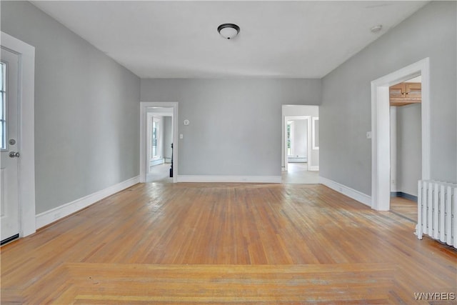 10470 Main St, North Collins, NY 14111 - unfurnished room featuring radiator heating unit, a smoke detector, and wood finished floors