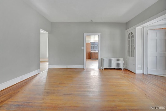 10470 Main St, North Collins, NY 14111 - unfurnished room with radiator and light wood-style flooring
